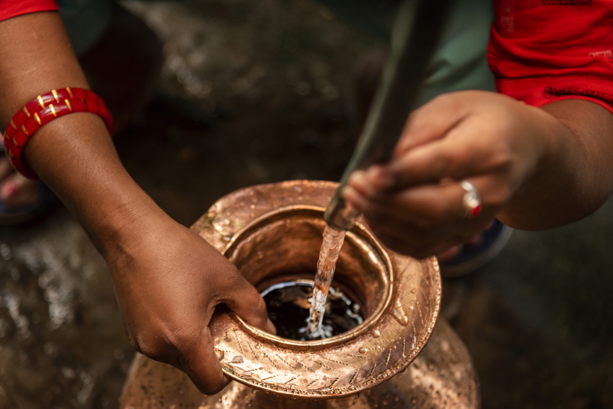 Mamta Biswa, a 37 years old lady who works in Barnesbeg Tea Estate and a peer educator of menstrual health management  in her village Godamtam withiin Barnesbeg Tea Estate under Darjeeling district in the state of West Bengal in India, is collecting drinking water.